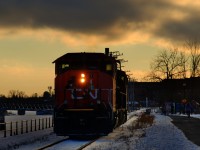 After bringing grain cars to Ardent Mills, CN 500's power is heading back to the main line close to sunset. It is on the East Side Canal Bank Spur, with the snow-covered Lachine Canal at left and a path at right.