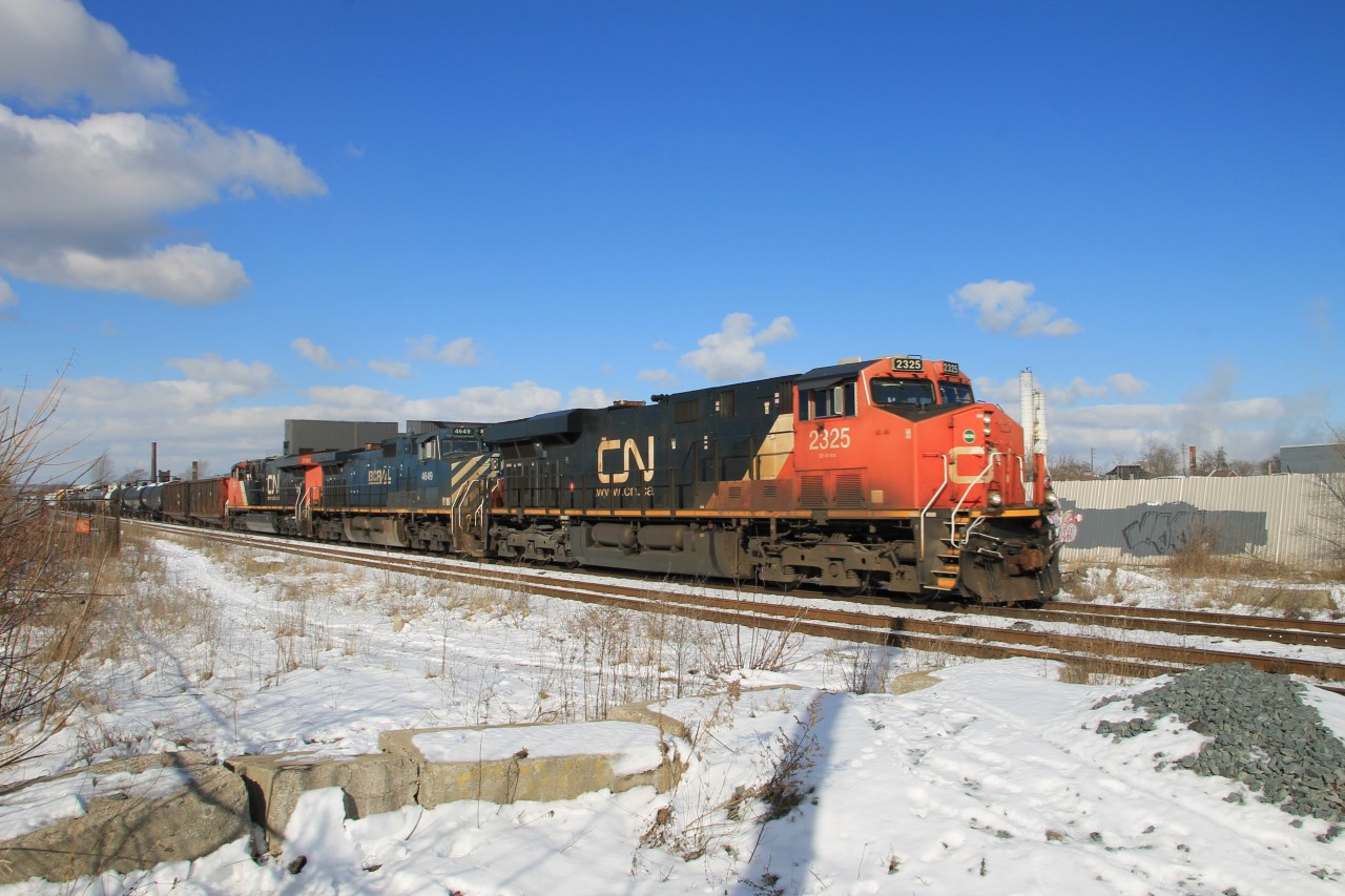 On a beautiful sunny morning CN 2325 leads BCOL 4649 and CN 2304 eastward of the north track of the Grimsby Sub. about to enter the crossing at Gage Avenue. I'm guessing this is 421.