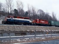 HLCX SD40-2 6210 and CP SD40-2 5731 lead a eastbound/northbound freight alongside Highway 403 at Desjardins near Hamilton Junction. Lease unit HLCX 6210 was formerly BC Rail 742 (pictured still in its old paint), and originally built for the Kennecott Copper Company as KCC 107. Trailing unit CP 5731 sports the new "System" or "Dual Flags" livery that CP introduced in 1993, in part to put greater emphasis on its Canadian and American rail network (now owning the SOO Line, MILW and D&H operations in the US. The shade of red used was SOO's Candy Apple Red). 
<br><br>
The first car following the power is CP 84999, part of a group of 50' newsprint cars that CP added extra height to to accommodate double-stacking newsprint rolls inside.
<br><br>
<i>Reg Button photo, Dan Dell'Unto collection slide.</i>