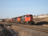 Three GM's CN 5775, CN 8013 and CN 5630 are on the point as M397 hustles down the south track having just passed L551 waiting at Tansley. The tail end lumber car on L551 is visible east of the Dundas St. overpass. 