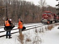 This train had quite the adventure today as the oversized CP 133 with CP 8727 and CP 9767 stalled out heading up the grade on the approach to Guelph Line. In the mean time, the crew ran out of hours and would have to wait several hours for a recrew from Toronto. The train was tied down for the crew change. The power for CP 135 was dispatched from Toronto to give them a final push up the hill. Here, the new crew has arrived and are passing on the needed information to get this train rolling. It would be about another 45 minutes to get the remainder of the brakes released and the air pressure up and off they went.