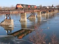 'Tis both scenic and peaceful as CN 502 trundles over the trestle and the iced, Grand River at Caledonia enroute to Three Fires and Garnet Yard.  CN 5654 and CN 2560 provide the power this day as the daily, morning freight snakes southbound along the Hagersville Subdivision originating Sarnia. A meaningful image for my 50th submission given my heritage and locale.  


