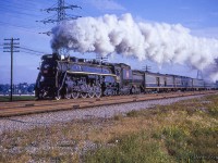With a plume of smoke billowing above, CNR 6167 approaches the Humber River on its way west out of Toronto during an Upper Canada Railway Society excursion to St. Thomas.<br><br>Originating at Toronto Union Station, the excursion ran to Hamilton where a pair of MLW RS3s; 3004, 3019, were added ahead of 6167 to assist the train up the Hagersville Subdivision to Caledonia, even though the 800 ton consist came in well under the 1,400 ton haulage capacity for Northerns up the grade. The diesels would be removed at Caledonia, the tender replenished with water, and the excursion would depart for Jarvis with a couple of runpasts along the way at Caledonia and Garnet, captured <a href=http://www.railpictures.ca/?attachment_id=47268>here by Bob Sandusky.</a>  Further runpasts would be held along the Cayuga west of Jarvis before arriving at St. Thomas <a href=http://www.railpictures.ca/?attachment_id=44906> where Doug Page captured the train </a> before it turned for home.<br><br><a href=http://www.railpictures.ca/?attachment_id=51044>Westbound over the bridge at New Sarum,</a> Photographer Unknown.