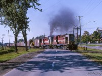 Continuing east out of Belleville, MLW RS10s 8594, 8594 head for Smith Falls.  <a href=http://www.railpictures.ca/?attachment_id=50793>Since last seen at Smithfield,</a> ALCO S2 7032 has been dropped at Trenton where it has been assigned as the yard switcher.
