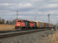 CN 7515 and CN 7509 pull down a cut of tri-levels on the Yard Lead and will then back into Oakville Yard as they put L554's train together.