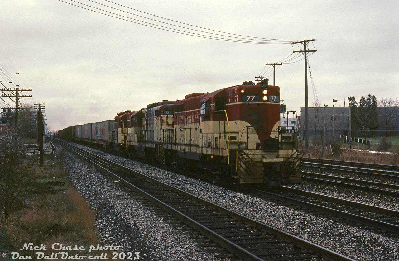 Operating over CP on their way to Agincourt Yard, TH&B GP7 77 and GP9's 401 & 403 hustle eastbound on CP's Belleville Sub around Mile 198 (on the approach to McCowan), passing over Sheppard Avenue near International Waxes (off to the left) in Scarborough. This is likely the CP/TH&B Starlight from Aberdeen Yard, coming off the TH&B at Hamilton Junction and taking CN's Oakville Sub, CP's Canpa Sub, Galt Sub, North Toronto Sub and Belleville Sub to CP's Agincourt (Toronto) Yard.

By this late in the game, TH&B's tired fleet of unrebuilt first generation GP7 and GP9 locomotives were on their last legs, and the Geeps were being run until major failures sidelined them. TH&B 77 would be taken out of service due to engine damage in December 1984, 401 would suffer an electrical failure in January 1985, and 403 would run until being sent for rebuilt in October 1987. All retired units were stored at CP's John St. Roundhouse before being sent to Angus Shops in Montreal for rebuilding into CP 1680-series yard units.
