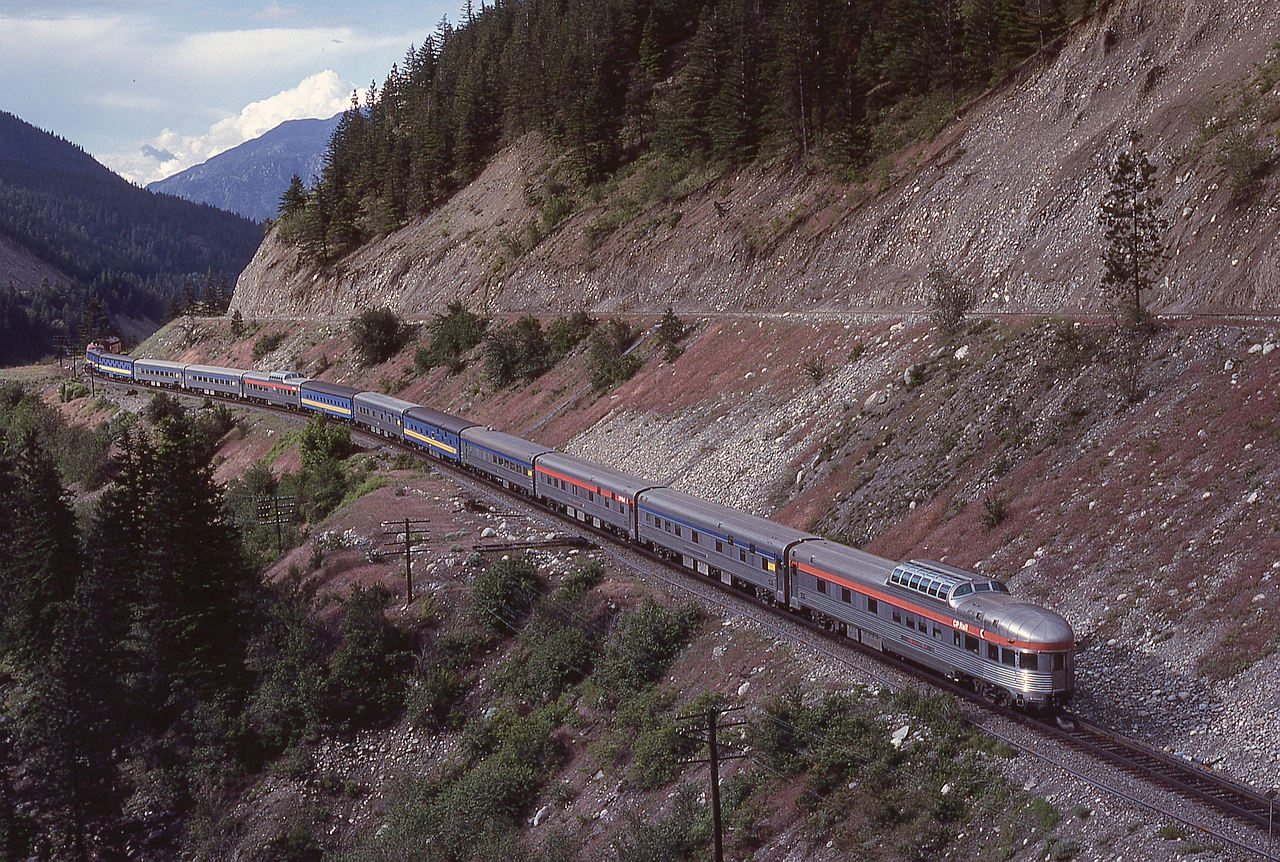 Following up on last week’s post showing VIA 2 on the CP Fraser River bridge near Cisco (http://www.railpictures.ca/?attachment_id=51394), here is the same train moments later on Saturday 1980-06-07, displaying a wide array of passenger equipment including RIDING MOUNTAIN PARK at the rear, and with the upgrade CP-to-CN connecting track visible above.