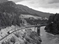 Viewed from a water barrel platform on CN’s bridge over the Fraser River at Cisco on Saturday 1980-06-07 at 1804 PDT, VIA train No. 2 with ex CP 1409 + CP 8527 + ex CP 1425 (note both VIA units still in full CP Rail livery) is at CP milepost 101 just after crossing to the east bank of the Fraser from the west.

<p>By no means do I intend to condone trespassing to obtain a photo.  Just 3 minutes earlier, I was surprised by a westward CN train (visible in the distance above the bridge), and shaken like the dickens by vibration of the CN bridge.  Today, a drone camera would be my vantage point of choice there.