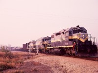 In the first year after CN took over Northern Alberta Railways, visual changes were not dramatic, limited to CN numbers replacing the originals but NAR emblems and lettering (including locomotive names) remaining intact.  Here is a GSL Turn from McLennan arriving at the former NAR/CN junction of Roma Jct., the south end of the Great Slave Lake line, at 1048 MDT on a smoky (distant forest fires) Friday 1981-09-18.  SD38-2 units 5701, 5702 and 5700 are ex NAR 402, 403 and 401.
