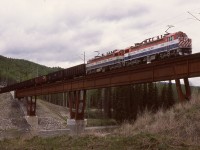 Heading for loading at the Quintette mine, BCOL GF6C electrics 6005 and 6003 are eastbound with coal empties under the 50 KV catenary and crossing the bridge over Bullmoose Creek.