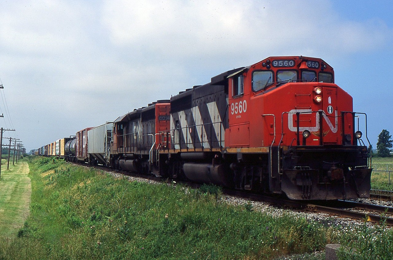 CN 449 with CN GP40-2(W) 9560 and CN SD40-3 6014 passing through Mile 12.84 on the CN Grimsby Sub in 1998.
