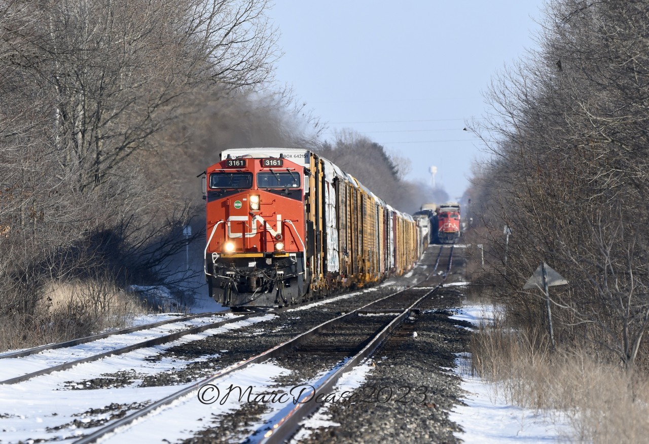 Train 301 approaches Wanstead west bound with CN 3161 as a solo leader and CN 3893 as a DPU. Train 385 is tied down on the south track awaiting the puller crew to take the train into Sarnia, ON.