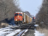 Train 301 approaches Wanstead west bound with CN 3161 as a solo leader and CN 3893 as a DPU. Train 385 is tied down on the south track awaiting the puller crew to take the train into Sarnia, ON.