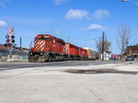 Streetrunning? Not quite, although CP H17-27 mimicked such a scene when it crawled through the shallow-angled Old Weston crossing where one could capture the awaiting road traffic in the frame with ease. RTC, West Tower and the crew onboard 6045 were at this point hurrying to get the train into the yard before the crew's 12 hours were up, but decision making was time consuming enough that H17 slowed down to wait for instructions. At the moment this photo was taken, they only had 10 minutes remaining on the clock, and the straw that broke the camel's back was a failure by West Tower to notify RTC of a last minute change to the track H17 was lined into, and so they took the light onto the incorrect track and had to come to a stop until the clock ran out. They would block the crossing for about 90 minutes until H19 was ordered to rescue and subsequently use this consist eastbound. Before heading home, I would notify some of the drivers about the situation and advised them to take a detour. Among these included an unfortunate fellow (waiting second in line just to the right of the silver car in image) who was driving his motorbike to Cyclewerx just 1 block on the other side of Old Weston for repairs for a faulty start-up, and figured taking the risk of turning off his bike was worthwhile given the short distance. It was only once I told him that H17 was out of hours that this decision would become regretful as he couldn't get it to start up again. I'm unsure if he waited the full 90 minutes or if he pushed his bike for the 1.5 km detour to the shop (compared to 280 m direct). Part of me hopes he figured a way to get it started after I left.