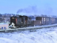 One of CN's many Toronto area transfers kicks up some snow as it makes good time returning to Toronto Yard on January 15th 1978.