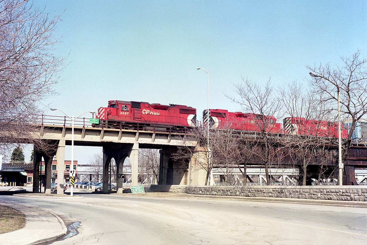 For me, a trio of GP38-2 locomotives was not all that common a catch around Niagara.  In this view I am alongside River Rd in the city as CP 3087, 3082 and 3062 roll into Canada via the old Michigan Central steel arch bridge, en route to Toronto.
This image is already 30 years old and the bridge has not carried rail traffic for at least 20 of those years.
