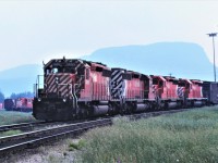 Smoke hangs heavy from early season forest fires in Thunder Bay, Ontario on June 26, 1980, as the first section of an eastbound train arrives behind a pair of SD40-2s and a pair of SD40s.  5655 leads the 5771, 5546, and 5540.  Location show is a guestimate as my memory does not go back that far!!