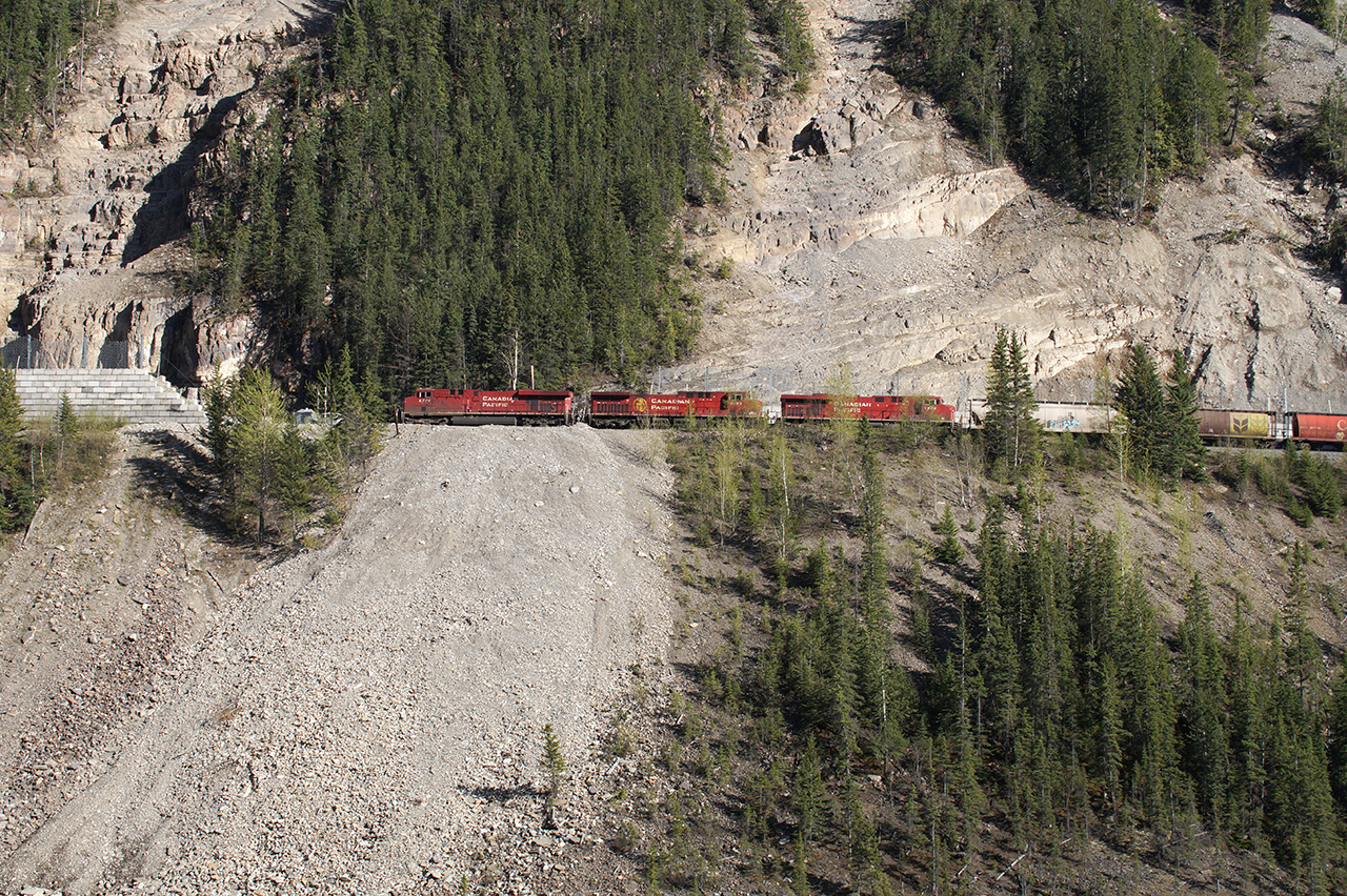 It takes a lot to make a train look small. Three GE's climb the Big Hill leaving Field for Calgary.