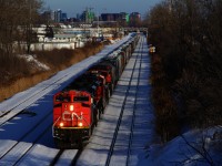 With two SD70M-2s off of CN 322 leading a pair of GE units, CN 527 is approaching Taschereau Yard with a long train after working Pointe St-Charles Yard.