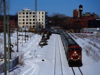 Loaded grain train CP 322 is nearly into the Port of Montreal as it passes the unused and snow-covered Hochelaga yard.