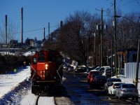 The Montreal East Switcher is heading light power to pick up empties at Bitumar. This spur closely parallels a residential street.
