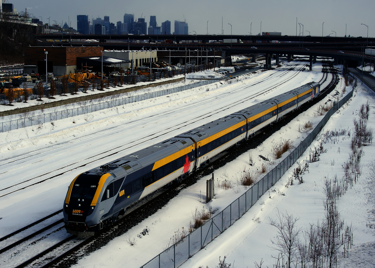VIA 33 has its once a week Siemens consist as it passes the skyline of downtown Montreal.