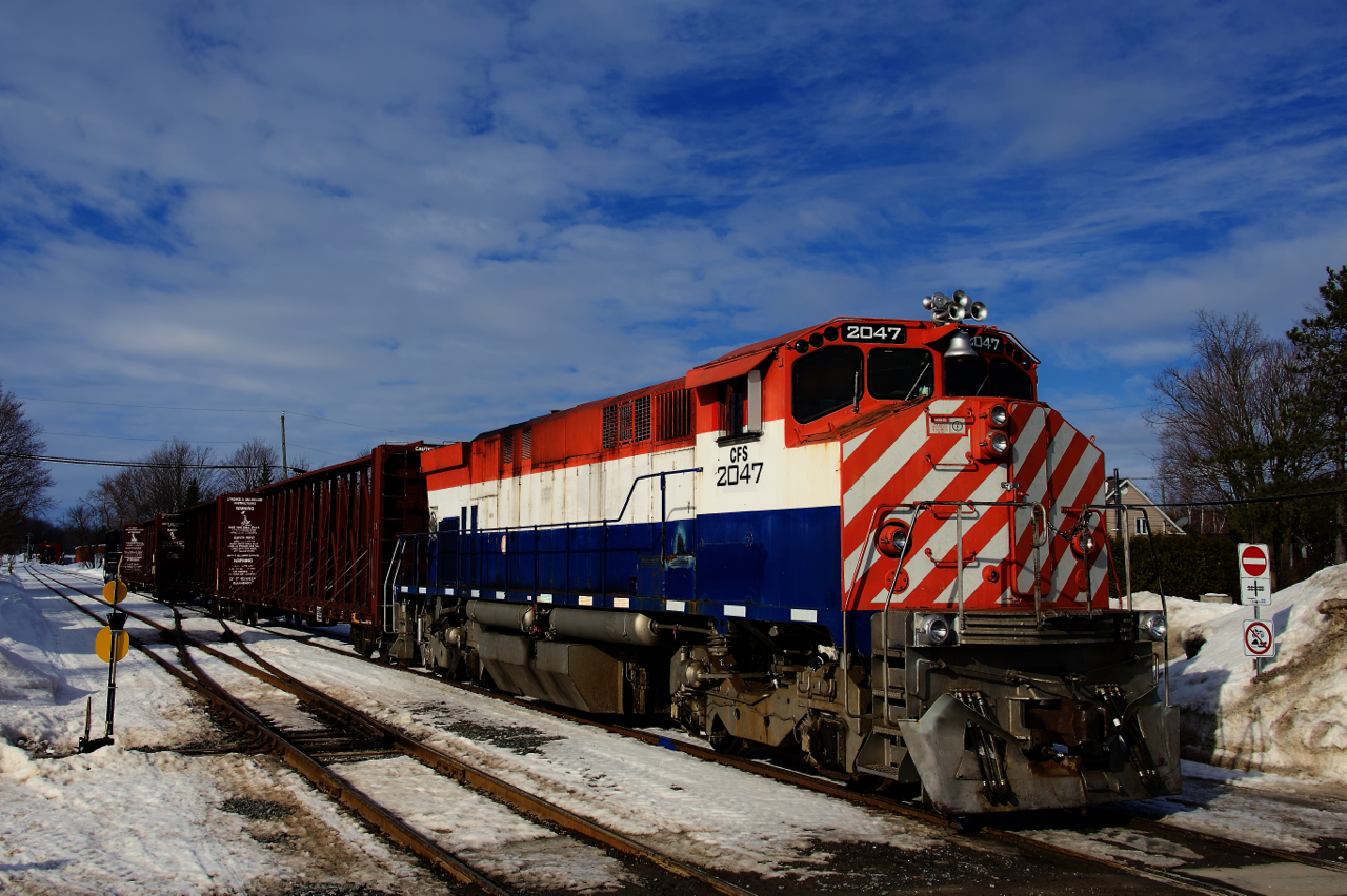 After being left in a lumber yard for the day, CFS 2047 has been coupled onto three centrebeams and is being pulled west. After a few more moves, the centrebeams will be left for a client here and the power will return to the Sartigan's nearby shops.