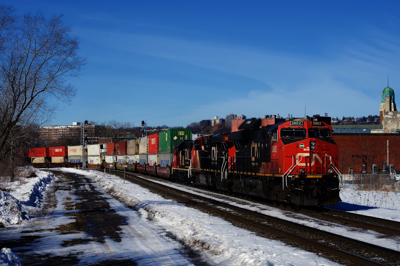 A pair of ES44ACs and a GP38-2 lead CN 120 around a curve.