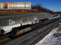 CN X321 is leaving Turcot Ouest after lifting cars off the Freight Track as VIA 35 passes it on the South Track with a stainless steel consist.