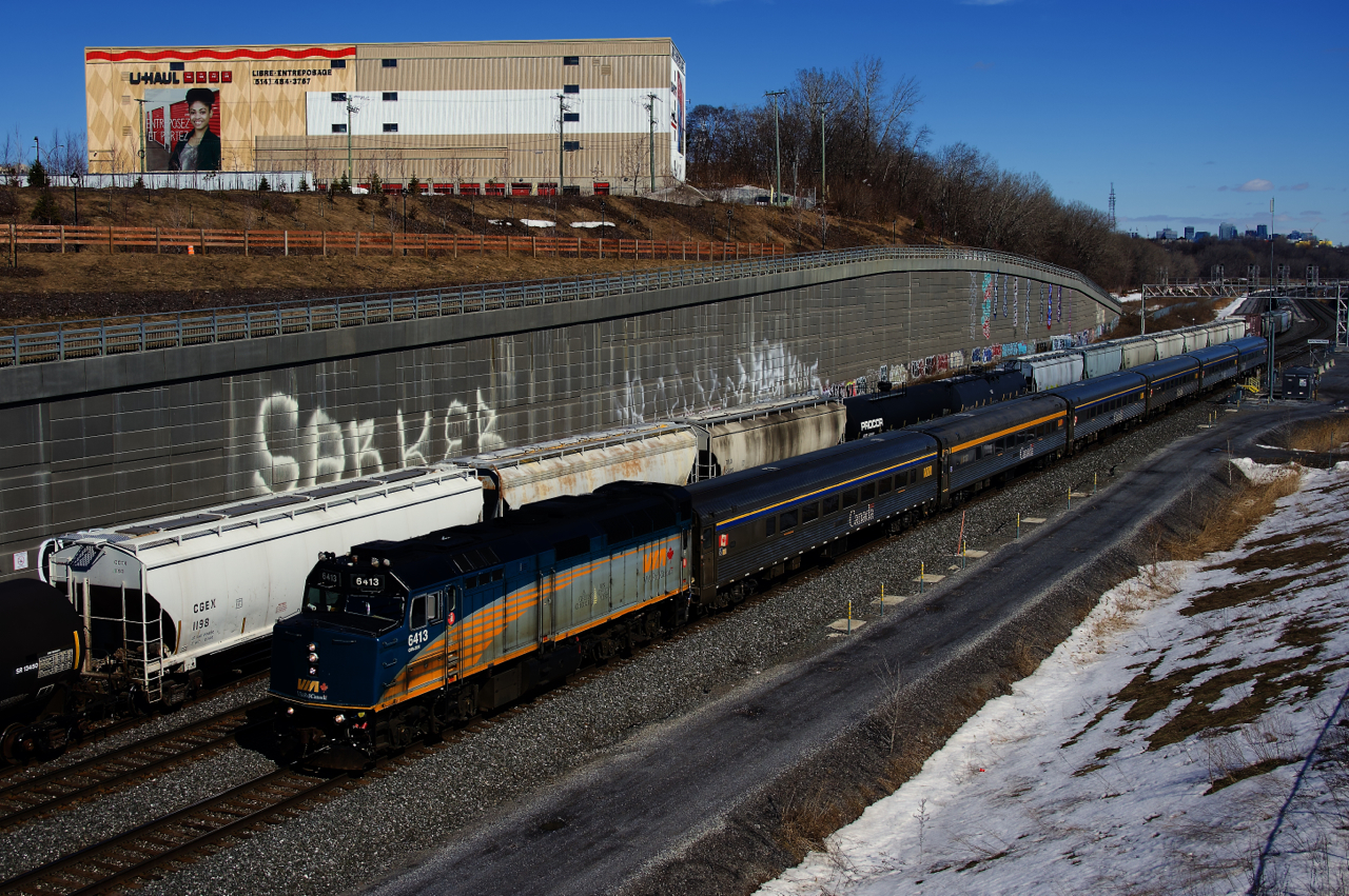 CN X321 is leaving Turcot Ouest after lifting cars off the Freight Track as VIA 35 passes it on the South Track with a stainless steel consist.