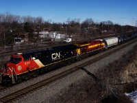 The Wisconsin Central heritage unit is trailing as CN X321 heads west with 138 cars. In the background is a foreman on the CP Vaudreuil Sub.