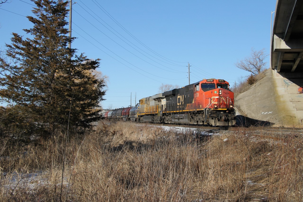 CN 2879 and CN 3938 are keeping M397's train under control as they duck under the Plains Road overpass on the North Track down the grade toward Burlington West and the Oakville Sub..