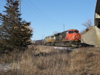 CN 2879 and CN 3938 are keeping M397's train under control as they duck under the Plains Road overpass on the North Track down the grade toward Burlington West and the Oakville Sub..