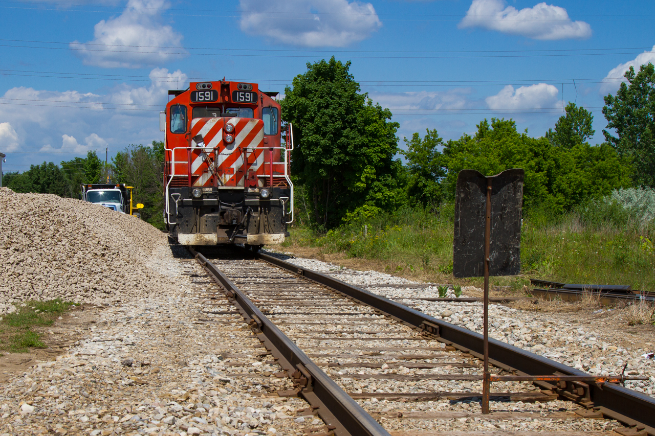 On a warm June afternoon, what I believe is OSR Guelph Junction Railway division's job #2 has stopped short of a Rule 41/841 red flag while wyeing their power on the Guelph North Industrial Spur.