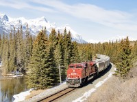 Slowing with the next signal showing advance clear to stop, CP 7034 leads solo an empty grain train east. It will stop at the next signal as the Exshaw switcher was working in the block ahead.