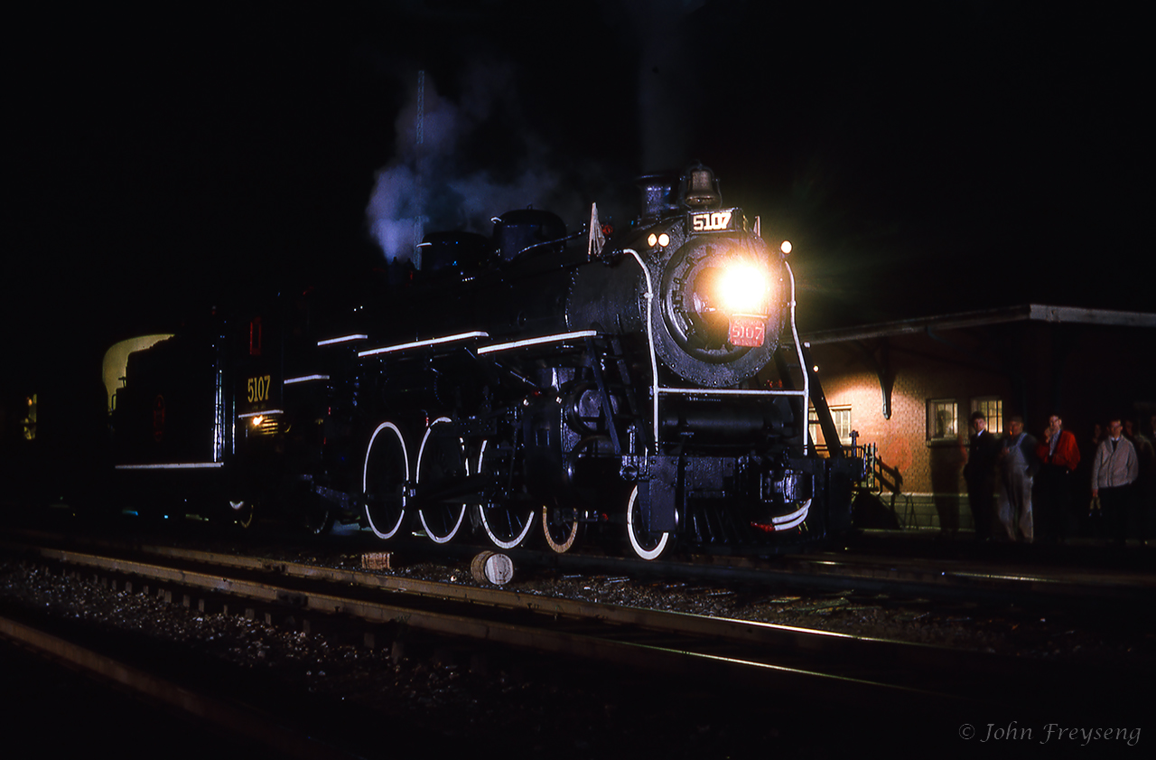 The weekend of October 13-14, 1962 provided railfans in the Montreal area with two excursions out of Central Station behind two steam locomotives. The Saturday trip would be led by J-4-d Pacific 5107, and the Sunday trip double headed with 5107 and U-2-c 6153. These trips run by the Canadian Railroad Historical Association were supported by the Upper Canada Railway Society.CNR 5107 is seen in front of the St-Hyacinthe station during the last water stop of the evening, giving photographers the opportunity for night shots. The six car train had departed Central station track 9 that morning at 0829h making a water stop here at St. Hyacinthe, as well as at Richmond, and three photo runpasts. One more runpast would be held between Richmond and Sherbrooke before turning the train for the return to Montreal, stopping for three more runpasts and water on the way. Back in Montreal, 5107 would be cut off at Bridge Street, leaving the consist in the care of MLW S4 8062 for the last couple of miles into Central Station. Today, CNR 5107 is on display in Kapuskasing. Bill Thomson caught 5107 at Mimico in the summer of 1958.Scan and editing by Jacob Patterson.