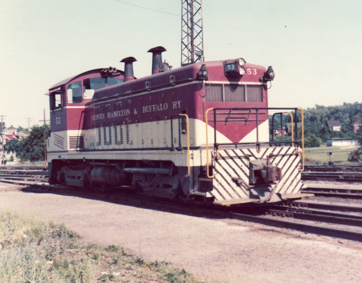 TH&B 53 is an NW-2 from EMD in LaGrange, IL with serial number 5705, built in January of 1948. It was sold to Atlas Specialty Steel in Welland, ON for scrap in May of 1988. I captured it around the Aberdeen Yard complex back in the summer of 1974.