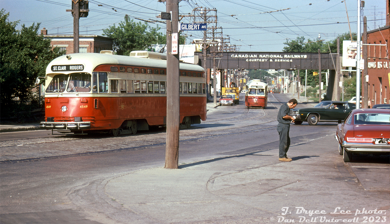 Running out the last few days of streetcar service on Rogers Road, TTC PCC 4549 heads eastbound on Rogers Road at Gilbert Avenue, passing a local "GAS" service station and either an attendant or customer attending to a car being fueled. Another TTC 4500-series (A8-class CC&F) PCC follows close by, ducking under the CNR Newmarket Subdivision bridge on a Rogers (to Wychwood - carhouse return) run. The last streetcar would run on Rogers Road three days later on July 19th 1974, and the route would be replaced by trolleybuses.

TTC 4549 would fair a little bit better. It would soldier on into the 1980's until the A8-to-A15-class rebuild program, and become one of two PCC's the TTC restored to their original paint/appearance (and kept their old numbers, 4500 and 4549, unlike others renumbered into the rebuilt 4600-series). Both remaining 4500's would be retained by the TTC as part of its historical fleet after the others were sold or donated in the mid-90's.

J. Bryce Lee photo, Dan Dell'Unto collection slide.