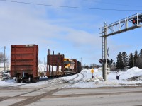 The tail end of KRC's Pukatawagan Mixed has cleared the 3rd Street West (Provincial Road 285) crossing and begins its northwest journey out of The Pas. The end of train device is firmly attached and connected to the trainline air hose of the trailing bulkhead flat. Today's Puk Mixed consisted of units PRLX 2265 & PRLX 2269, baggage car KRC 3248, combination coach/baggage car KRC 5648, 3 plug door box cars KRC 691792, unknown, & KRC 410581, bulkhead flat WC 38289 with a load of new track ties, flat car KRC 667100 with a school bus, and bulkhead flat KRC 701213 with an unknown bagged cargo. Quite the spectacle.