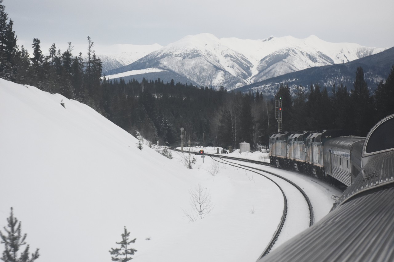 VIA #2 The Canadian has a clear signal at Mile 80.7 on CN's Albreda Sub. Canoe River, BC on March 7, 2020. I like the high mast searchlight signals on the main, and the dwarf searchlight signal for the siding. The hot air switch heater has been doing its job as the switch points and more are snow free.