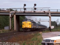 VIA FP9 6510 and F9B 6614 haul train #73 westbound on the Oakville Sub through Aldershot, passing under the signalbridges at Waterdown Road. An ex-CP baggage-dorm trails the power, followed by eight of VIA's ex-CN blue & yellow fleet. 
<br><br>
After retirement, VIA 6510, the only CN/VIA FP9 with its bell mounted on the right side (above the engineer) was donated to the City of Thunder Bay and is currently on display at Kaministiquia River Heritage Park. VIA 6614 became Algoma Central 1762.
<br><br>
<i>Bill McArthur photo, Dan Dell'Unto collection slide.</i>