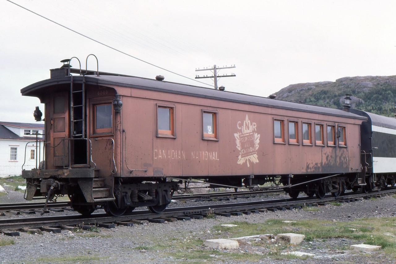 BOARDING AT BRIGUS JUNCTION - Travelling with four University of Toronto friends - including the late James A. Brown - to celebrate Canada's Centennial by riding Newfoundland's endangered passenger train 'Caribou', John Freyseng of Ontario was able to capture some amazing narrow gauge images. Just before boarding, he photographs the rear of CN Train No. 212, the Carbonear Mixed before entering the mainline on the St. John's Subdivision on June 22, 1967. As evidenced by the rear end car 6009, John's keen eye captured the unique railroading found only in Canada's tenth province and perhaps in all of North America. Caboose/Cabin Car 6009 was originally built as second Class Coach 114 in November 1902 by the Reid-Newfoundland Company in St. John's and its spartan interior of wooden benches and bunks for the crews remained until the very end. By the early 1970's all such cabin cars on the three operating branchlines were replaced by the steel coaches from the now cancelled 'Caribou'. Having chased and photographed this train up and down the Carbonear Branch, John would board and experience the ride for himself as far as Holyrood where he would detrain to join his friends in pursuing it to St. John's. More of 1967 John Freyseng beautiful photos can be seen in my TRAINS OF NEWFOUNDLAND, released by Flanker Press in both hard and softcover editions.