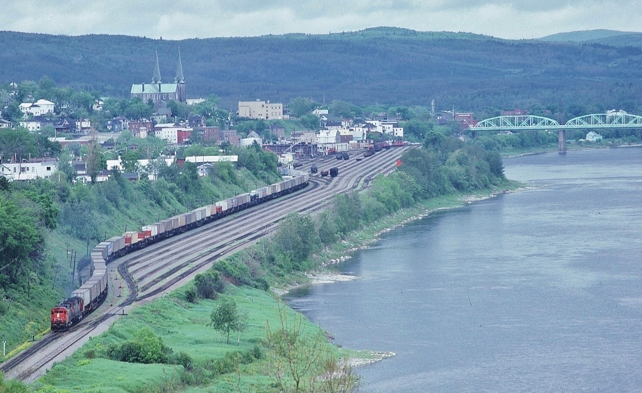 Look at that string of  T O F C 's !


  and after the crew change and a TOFC lift, 


  a pair of MLW 1967 built C-630M's dig in for the climb up the St. John River Valley.


  At the St.John River Valley lookout, 


  Deep in Republic of Madawaska territory,  June 10, 1981 Kodachrome by S.Danko


       CPR Edmundston   


sdfourty