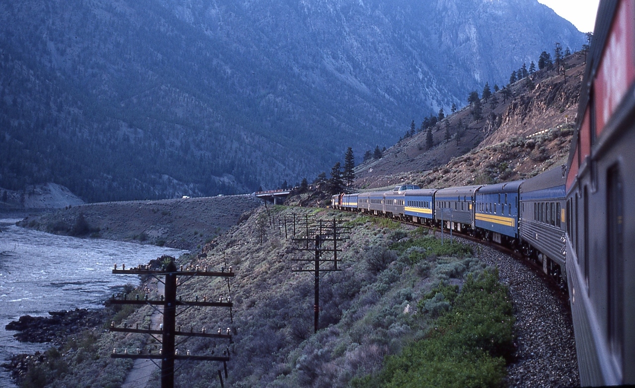 The vestibule view from all CP Rail Chateau Argenson 14201,


   reveals an all GMD power lashup including a leased CP Rail GP9


   In the Thompson River Canyon, near Spences Bridge, VIA #2 May 16, 1980  Kodachrome by S.Danko


   noteworthy


   at lower left, near the river bank is the original road bed.


   And behind the photographer, and no longer on the VIA roster, is all CN in black & white livery Grand Codroy River 2131 ((10 roomette, 6 bedroom)(ex FEC Argentina)) and all CP Rail Riding Mountain Park 15512.


  more ex CN


       E series   


sdfourty