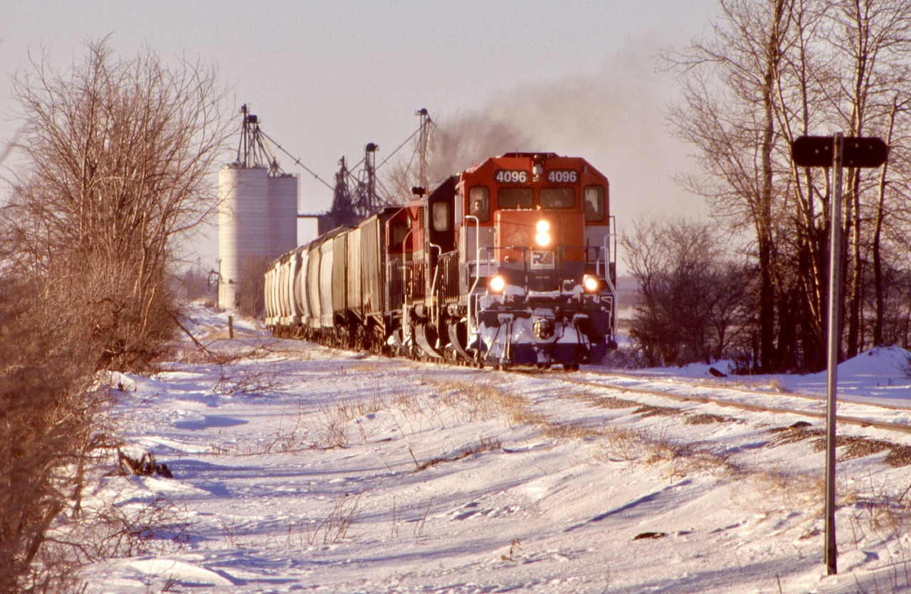 Always looking like a granger. The GEXR always had that granger look, especially west of Stratford. Covered hoppers dominate pretty much all trains here, loaded with either grain or salt. One of the several grain elevators on the two branches can be seen in the background as 581 throttles up and heads eastward for Stratford under late winter light.