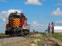 <b> (Skip to paragraph 2 to read about the locomotive) </b> During the summer I had been making some intensive cycling excursions to the Weyburn Subdivision from Regina when my ride wasn't available for the week. I road biked 55km on the first excursion to Milestone which yielded 8781 S on 148 ( <a href="http://www.railpictures.ca/?attachment_id=50222"> http://www.railpictures.ca/?attachment_id=50222 </a> ) which led to a scare on the ride home when my rear tire burst. Fortunately a friend of mine picked me up that day after I lugged my bike 4km in the 32º heat to the nearest town. This time round I came overprepared and my backpack was filled with spare water bottles, tire tubes and bike repair equipment, which almost worried me about a self-fulfilling prophecy situation in which the extra weight risked another burst. Fortunately no such outcome came to fruition and I was able to complete the full 100km ride round trip. Having no space to pack a lunch that day I made a calorie-heavy stop at Canadian Superstore on the way home.
<br>
<br> If you know any retired guys from Louisiana in the 90s, MRI 2180 may induce some nostalgia in them, having been built as a GP7 for ATSF, and spending some time in the hands of New Orleans and Lower Coast Railroad around then. A crew who used to run the unit reached out to me on Facebook to explain the inside joke about this unit, explaining that the paint they applied to the locomotive prior to this scheme was originally supposed to be a bright red, but quickly got bleached in the sun to a purple color after entering service. The group of crews who frequented this locomotive gave this ugly duckling the appropriate nickname "Barney" to refer to the unit (Seen here <a href="http://www.rrpicturearchives.net/showPicture.aspx?id=2486924"> http://www.rrpicturearchives.net/showPicture.aspx?id=2486924 </a> ). Eventually, the locomotive was sold to the NPRR-based (Northern Plains Railroad) Mohall Railroad Inc. leasing company, which apparently happened without much warning to the crews, and worried them that the locomotive had been scrapped. The guy who reached out was relieved to see my pictures of this locomotive, knowing their old Barney lives on, and intends to one day plan a vacation to Saskatchewan hopefully before its current lease ends. Today 2180 currently calls Corinne home to work the Richardson International Grain Elevator for spotting duties when needed. 