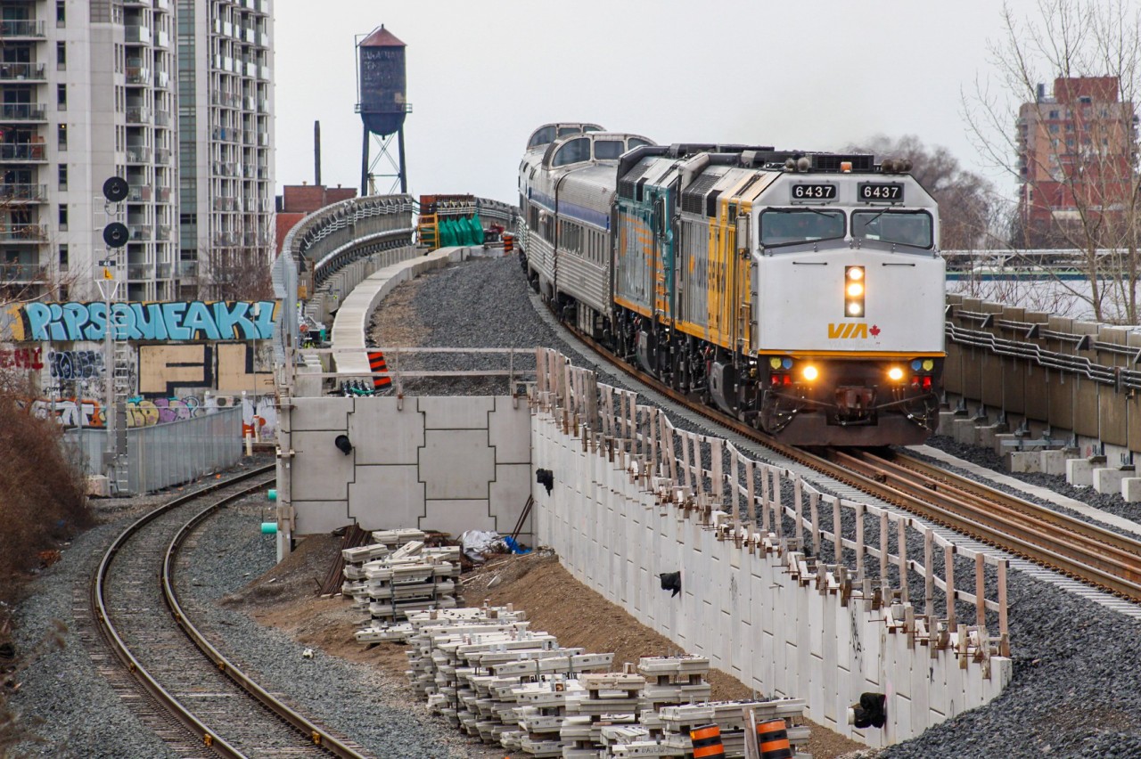 VIA 6437 and 6440 cement themselves in the history books as the first F40PH-3s to use the brand-new Davenport Diamond Guideway after 3 years of construction, leading the Wednesday VIA 1 departure from Toronto Union. Just moments prior they had rolled past the ex-Canadian General Electric water tower which can be seen peering over the horizon, now a historical artifact on the property owned by Ubisoft, which purchased the building associated with the water tower to be used as a studio some years ago. Further to the left, you can see one of the recently retired searchlights for Davenport, which saw its last moments of action on March 31st. As sad as it was to see history go (as well as a beneficial wild card in delaying important CP trains for slow railfans getting trackside), I was lucky to find this angle during the last day of Davenport Diamond GO operations. When I got here today, my initial plan was to use the digital viewfinder and extend my arms in the air to clear the fence out of the shot, but fears of human error encouraged me to eventually make the difficult climb atop the ~7ft tall wooden fence bordering Davenport Village Park to get this slightly aerial view.