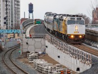 VIA 6437 and 6440 cement themselves in the history books as the first F40PH-3s to use the brand-new Davenport Diamond Guideway after 3 years of construction, leading the Wednesday VIA 1 departure from Toronto Union. Just moments prior they had rolled past the ex-Canadian General Electric water tower which can be seen peering over the horizon, now a historical artifact on the property owned by Ubisoft, which purchased the building associated with the water tower to be used as a studio some years ago. Further to the left, you can see one of the recently retired searchlights for Davenport, which saw its last moments of action on March 31st. As sad as it was to see history go (as well as a beneficial wild card in delaying important CP trains for slow railfans getting trackside), I was lucky to find this angle during the last day of Davenport Diamond GO operations. When I got here today, my initial plan was to use the digital viewfinder and extend my arms in the air to clear the fence out of the shot, but fears of human error encouraged me to eventually make the difficult climb atop the ~7ft tall wooden fence bordering Davenport Village Park to get this slightly aerial view.