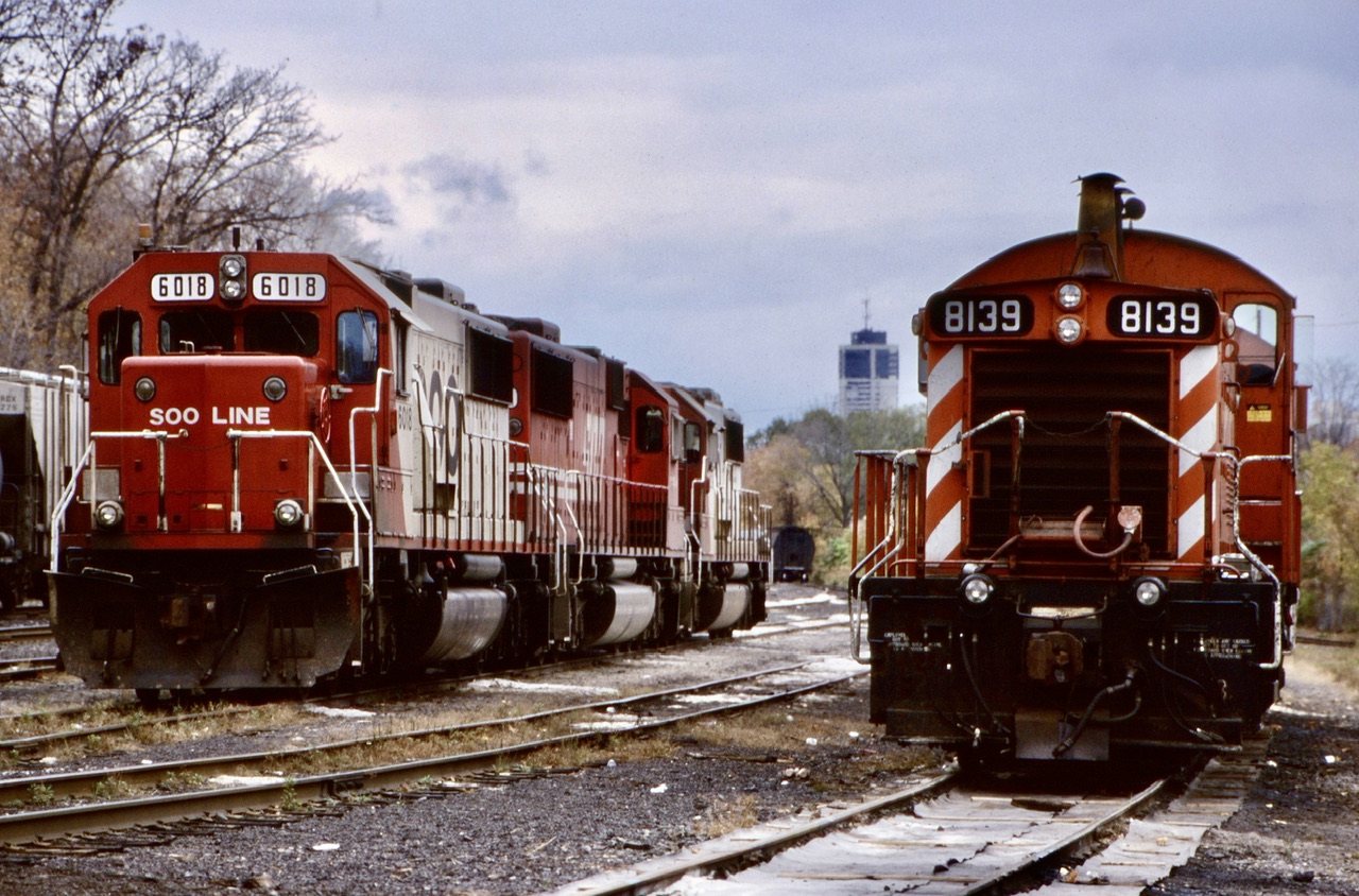 Some days the old TH&B Kinnear yard could get interesting. Here train 505 with a trio of SOO SD60’s have left their train in the distance on the main while the power has been brought to the yard office to wait on a fresh crew. The two SW1200’s were being used for the belt line job and any work at Aberdeen at the time and would eventually get bumped out of this role by GP9U’s.
