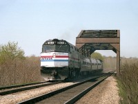 The USA-bound morning Amtrak #97, is seen crossing thru CN Iron Bridge on a nice sunny day. I like this shot for its simplicity; although I must admit I really miss the F40PH units compared to those rather blah looking P42s we see these days.
I do not see all that many photos taken from this location as it is not easily accessible. No idea what it is like there now, but I would assume there is a foot-path. And the trees are probably up.
In the past I have referred to this location as being Merritton, but according to my tattered old map of the area, the bridge is actually in the extreme north-east sliver of Thorold.   Who woulda thunk it?